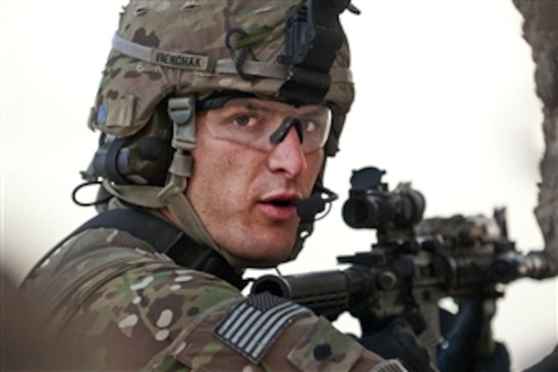U.S. Army Pfc. Justin Vnenchak maintains security in his sector while fellow paratroopers and Afghan policemen search a compound in southern Ghazni province, Afghanistan, on April 8, 2012.  Vnenchak is an infantryman assigned to the 82nd Airborne Divisionís 1st Brigade Combat Team.  