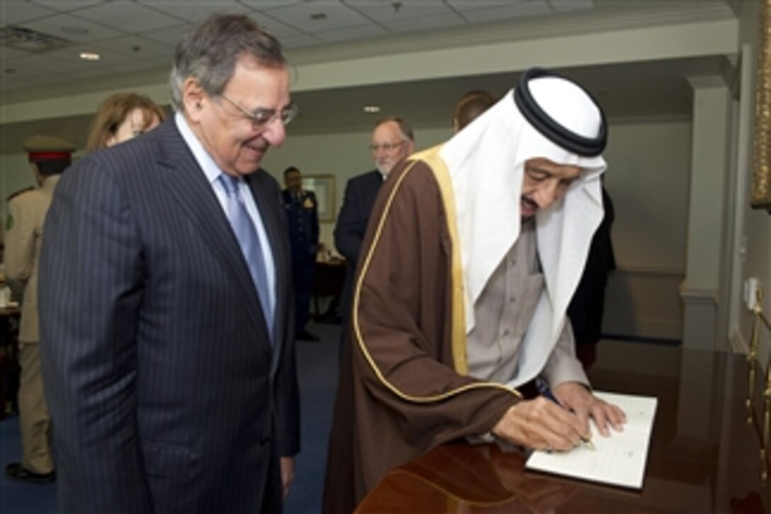 Secretary of Defense Leon E. Panetta stands with Saudi Arabian Minister of Defense Prince Salman bin Abd al-Aziz Al Saud as he signs the guest book prior to a meeting in the Pentagon on April 11, 2012.  
