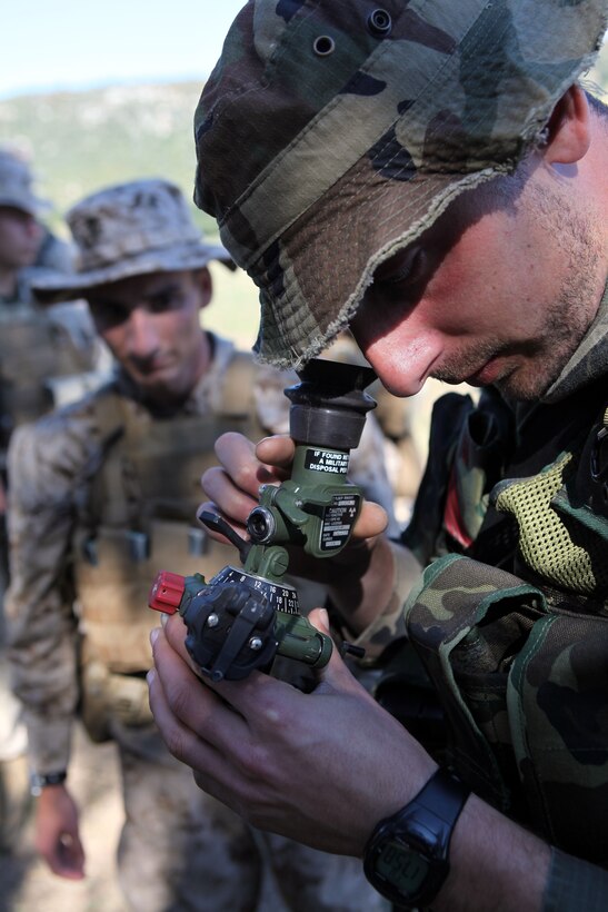 Cpl. Juan Vidana, a mortarman with Charlie Company, Battalion Landing Team 1st Battalion, 2nd Marine Regiment, 24th Marine Expeditionary Unit, watches an infantryman with the Spanish Marine Corps look through a mortar site April 16, here, during bi-lateral tactics training between the 24th Marine Expeditionary Unit and the Spanish Marine Corps. The 24th MEU, partnered with the Navy's Iwo Jima Amphibious Ready Group, is deployed to the European and Central Command theaters of operation to serve as a theater reserve and crisis response force capable of a variety of missions from full-scale combat operations to humanitarian assistance and disaster relief.