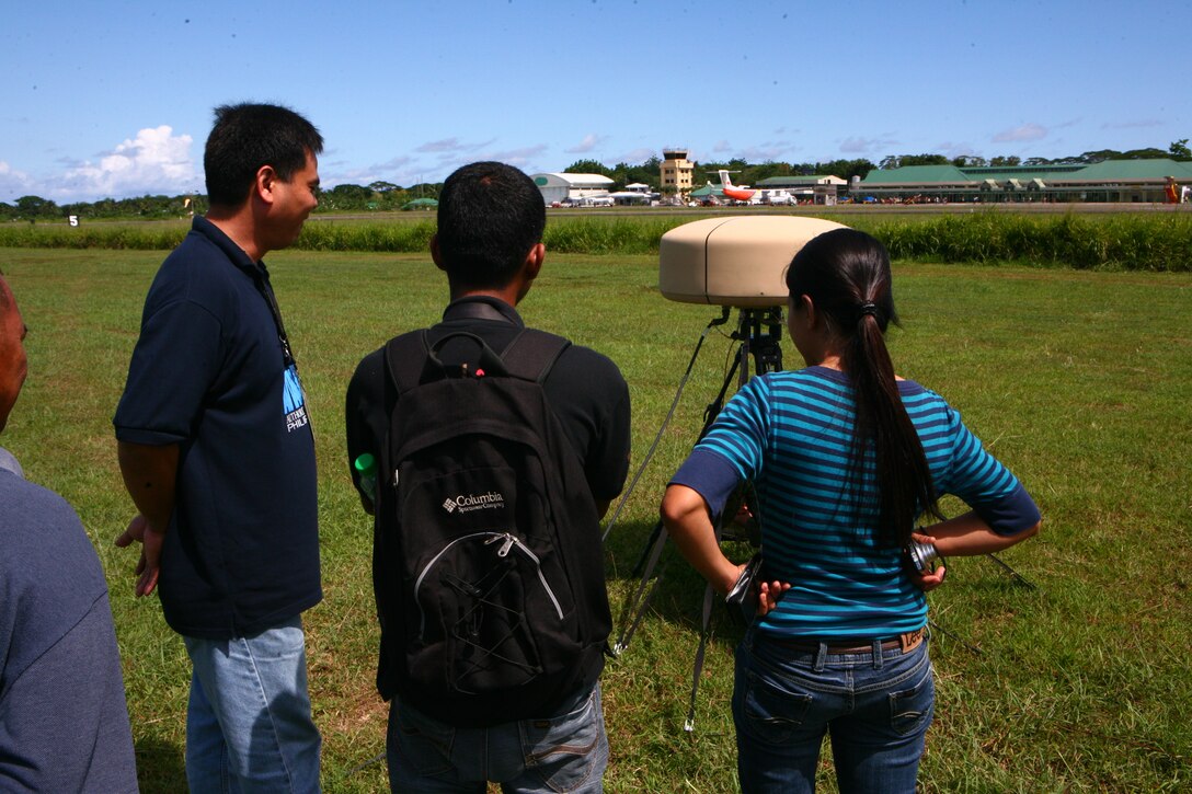 From left, Nathaniel T. Rodriguez, Mel Sabido and Lailane D. Balbino look at and discuss U.S. Marine Corps air traffic control equipment on Antonio Bautista Air Base on Puerto Princesa April 17, 2012. The Marine unit, part of Task Force Palawan, is currently training in Puerto Princesa for Balikatan 2012 (BK12). BK12 is a bilateral, joint exercise conducted annually between the U.S. and the Republic of the Philippines. This year marks the 28th iteration of the nations' exercise. Rodriguez, Sabido and Balbino are air traffic controllers at the Puerto Princesa Airport.
