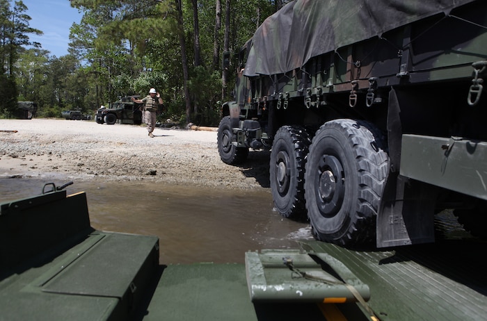 A Marine attached to 2nd Marine Logistics Group’s 8th Engineer Support Battalion guides a Medium Tactical Vehicle Replacement truck off of a seven-bay raft aboard Camp Lejeune, N.C., April 17, 2012. Several Marine Corps reservists attached to Folsom, Pa.-based Bridge Company Bravo, 6th ESB partnered with their active-duty counterparts from 8th ESB during the rafting exercise as part of their pre-mobilization training. (U.S. Marine Corps photo by Sgt. Justin J. Shemanski)