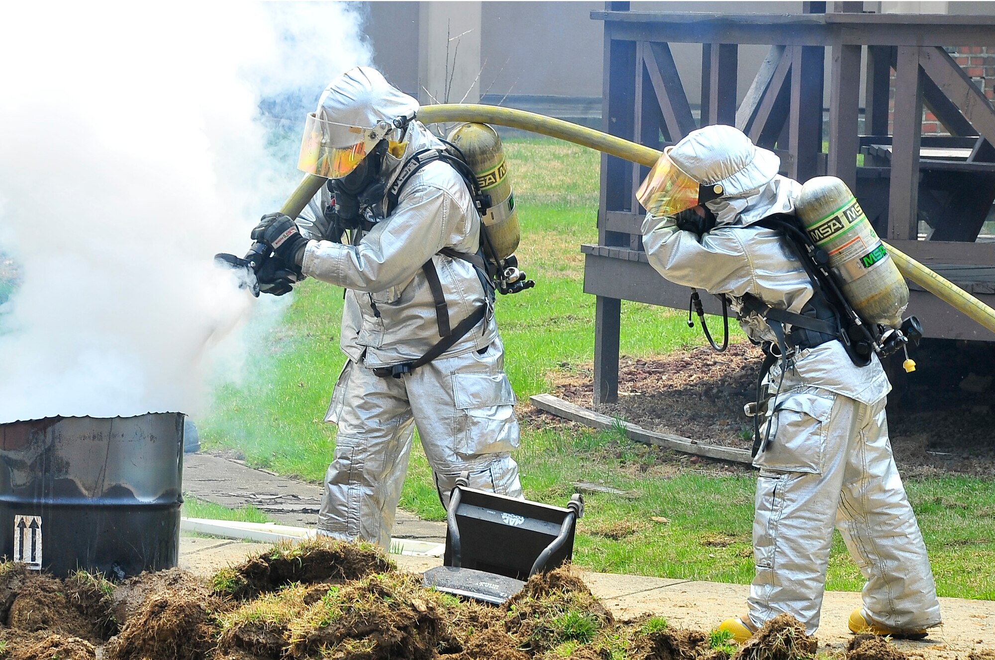 Members from the 51st Civil Engineer Squadron Fire Department, put out a fire during an Emergency Management Inspection here April 16, 2012. During the inspection the exercise evaluation team members were tested on their ability to evaluate Airmen. (U.S. Air Force photo/Senior Airman Adam Grant)