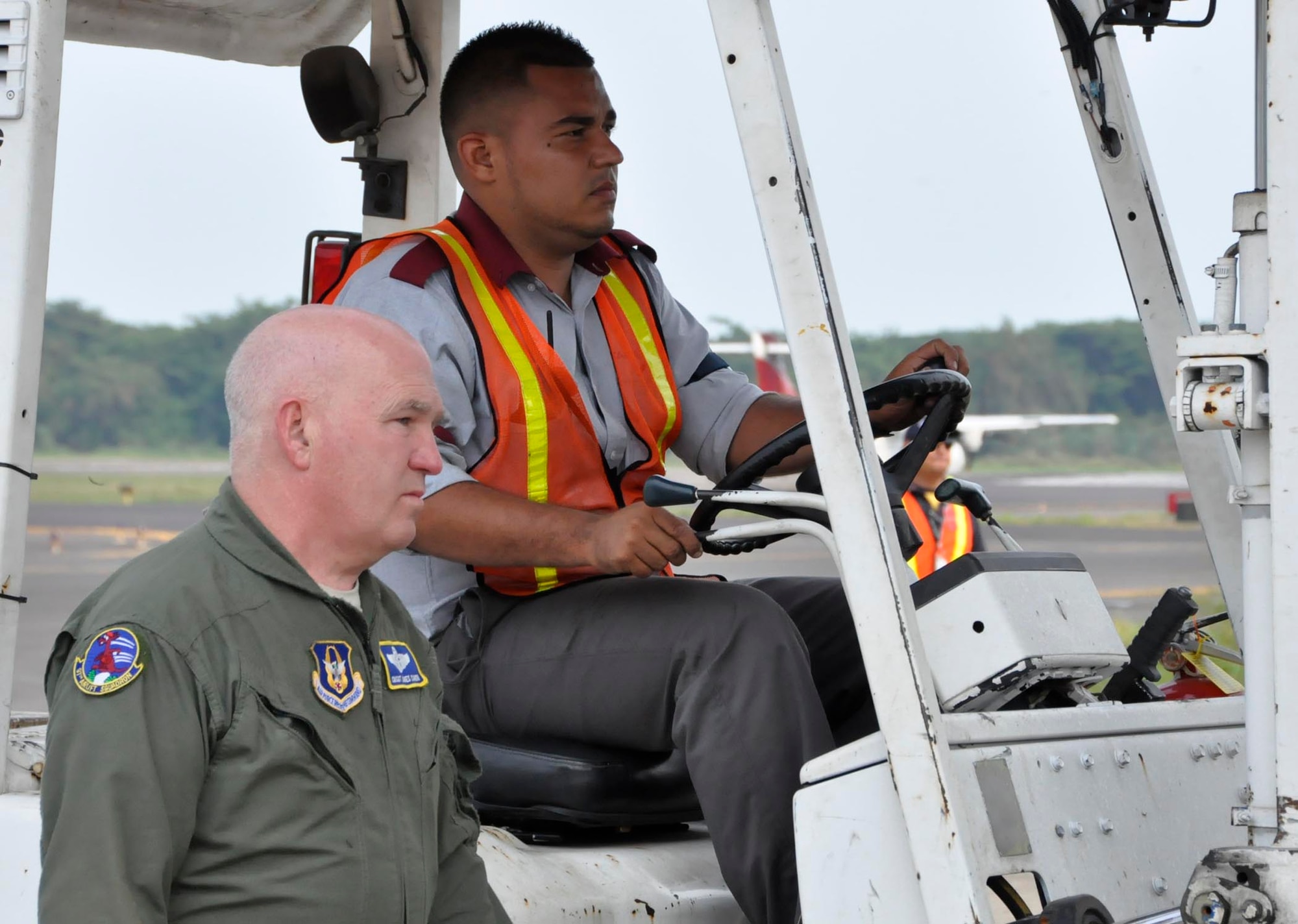Chief Master Sgt. Jim Caron, 97th Airlift Squadron resource manager, assists a Salvadorian forklift operator in unloading medical equipment shipped through the Denton Humanitarian Assistance Program. This was the 23rd Denton mission for the 446th Airlift Wing since 2005. (U.S. Air Force photo/Staff Sgt. Rachael Garneau)