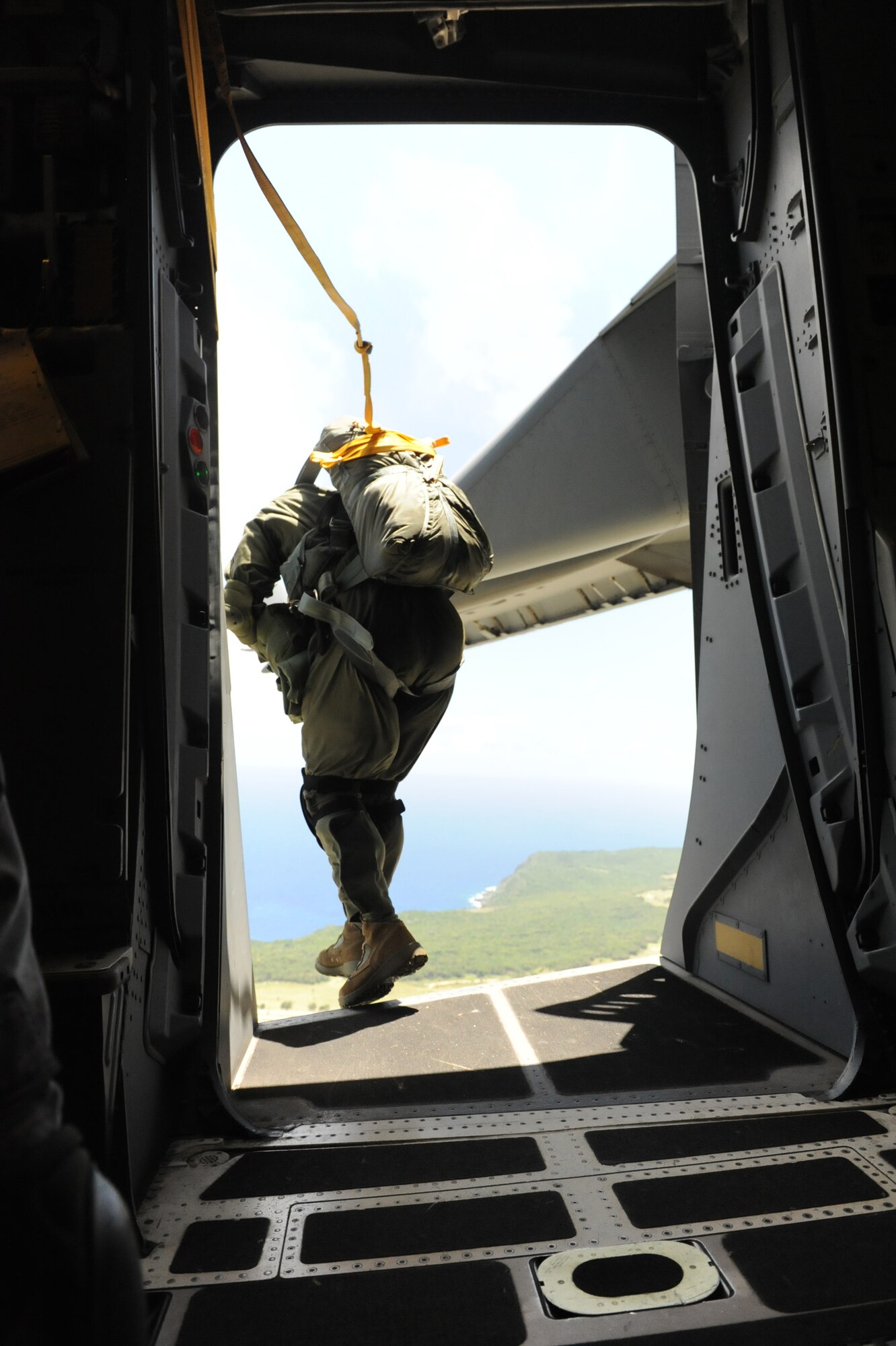 A static-line jumper jumps out of a C-17 Globemaster III from the 535th Airlift Squadron at Joint Base Pearl Harbor Hickam, Hawaii, April 6 at Andersen Air Force Base, Guam, while on a five-day mission to fly, execute airdrops, and foster joint service and international operability in the Pacific theater. During the mission, the aircrew dropped static-line personnel, heavy equipment platforms, high-velocity container delivery system bundles, low-velocity CDS bundles, and High-Altitude Low-Opening jumpers during their time in Guam. (U.S. Air Force photo by Staff Sgt. Nathan Allen)