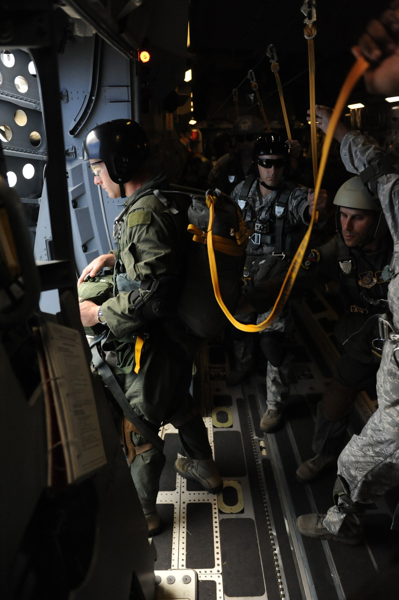 A static-line jumper from the 36th Contingency Response Group prepares to jump out of a C-17 Globemaster III from the 535th Airlift Squadron at Joint Base Pearl Harbor Hickam, Hawaii, April 6 at Andersen Air Force Base, Guam, while on a five-day mission to fly, execute airdrops, and foster joint service and international operability in the Pacific theater. During the mission, the aircrew dropped static-line personnel, heavy equipment platforms, high-velocity container delivery system bundles, low-velocity CDS bundles, and High-Altitude Low-Opening jumpers during their time in Guam. (U.S. Air Force photo by Staff Sgt. Nathan Allen)