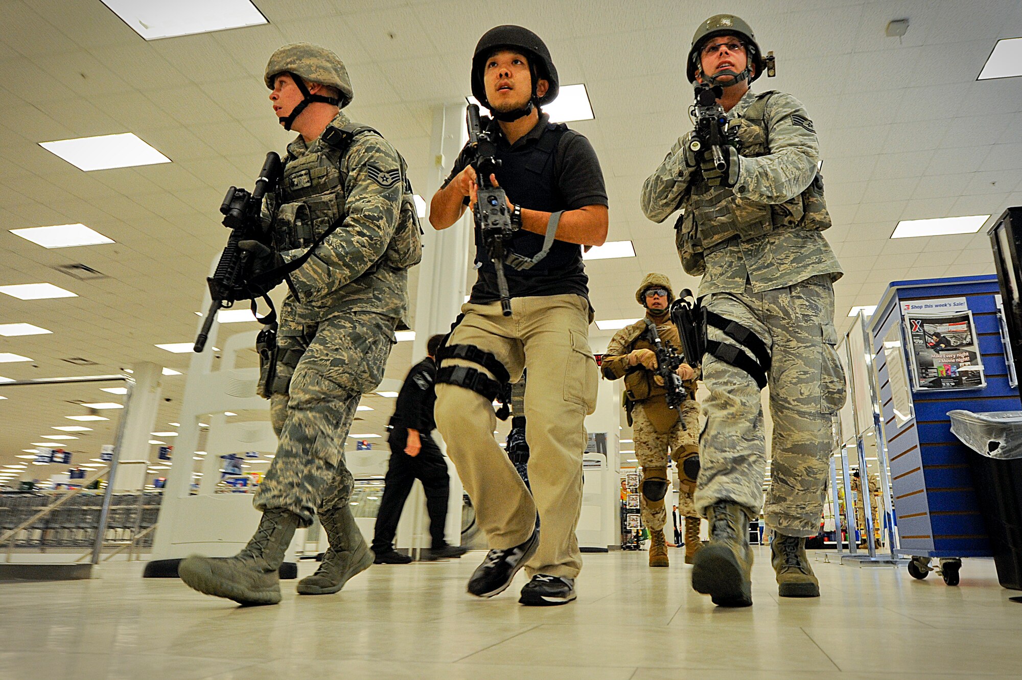 Members of the Pacific Air Forces High-Risk Response Training Team Two begin clearing the Exchange on Kadena Air Base, Japan, of possible simulated casualties and gunmen during an active-shooter scenario at the building April 13, 2012. During the training, members from all U.S. military branches and their civilian counterparts took turns leading teams in a high-tempo, high-risk scenario to better prepare them for potential real-world situations. (U.S. Air Force photo by Airman 1st Class Maeson L. Elleman/Released)