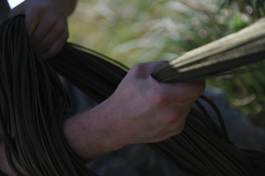 Senior Airman Daniel Allen, 647th Logistics Readiness Squadron combat mobility flight rigger from Joint Base Pearl Harbor Hickam, Hawaii, uses the “daisy chain” technique to field pack a parachute after it was used to drop a heavy equipment platform from a 15th Wing C-17 Globemaster III April 6 at the drop zone on Andersen Air Force Base, Guam, during a five-day mission to fly, execute airdrops, and foster joint service and international operability in the Pacific theater. During the mission, the aircrew dropped static-line personnel, heavy equipment platforms, high-velocity container delivery system bundles, low-velocity CDS bundles, and High-Altitude Low-Opening jumpers during their time in Guam. (U.S. Air Force photo by Staff Sgt. Nathan Allen)
