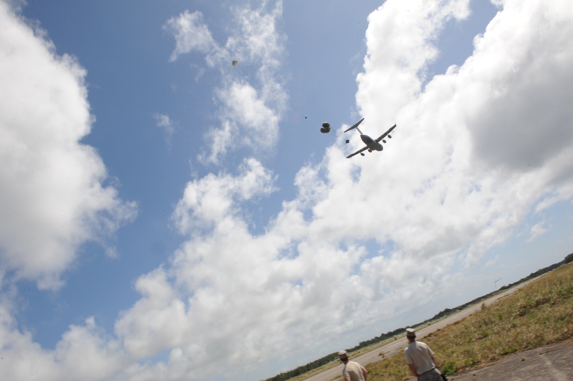 A C-17 Globemaster III from the 535th Airlift Squadron at Joint Base Pearl Harbor Hickam, Hawaii, drops a heavy equipment platform April 6 over the drop zone at Andersen Air Force Base, Guam during a five-day mission to fly, execute airdrops, and foster joint service and international operability in the Pacific theater. During the mission, the aircrew dropped static-line personnel, heavy equipment platforms, high-velocity container delivery system bundles, low-velocity CDS bundles, and High-Altitude Low-Opening jumpers during their time in Guam. (U.S. Air Force photo by Staff Sgt. Nathan Allen)