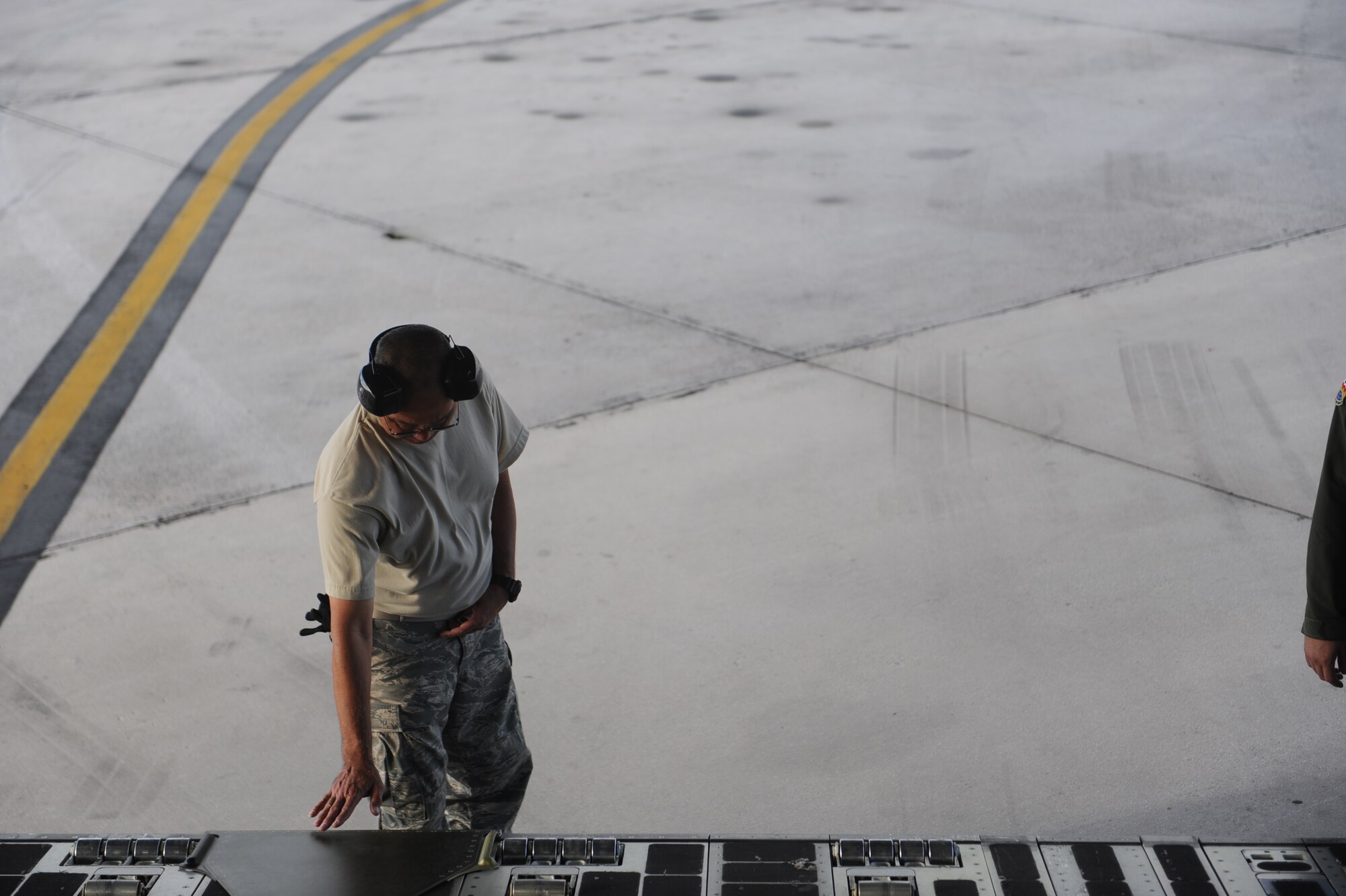 Tech. Sgt. Miles Nakamura, 154th Aircraft Maintenance Squadron flying crew chief, performs pre-flight maintenance on a C-17 Globemaster III from the 535th Airlift Squadron at Joint Base Pearl Harbor Hickam, Hawaii, April 9 at Andersen Air Force Base, Guam, while on a five-day mission to fly, execute airdrops, and foster joint service and international operability in the Pacific theater. During the mission, the aircrew dropped static-line personnel, heavy equipment platforms, high-velocity container delivery system bundles, low-velocity CDS bundles, and High-Altitude Low-Opening jumpers during their time in Guam. (U.S. Air Force photo by Staff Sgt. Nathan Allen)
