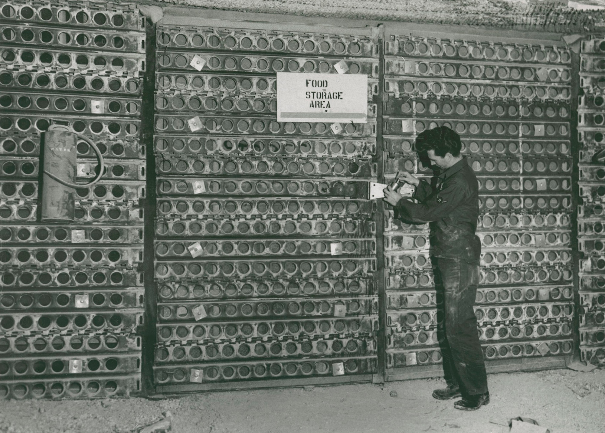 A volunteer checks the food supply in the community fallout shelter in the Borax Mine. The shelter was assembled in 1962 in response to escalating tensions between the United States and Soviet Union. Although the shelter was able to accommodate 17,000 people, fortunately it never had to be used. (Courtesy Photo)