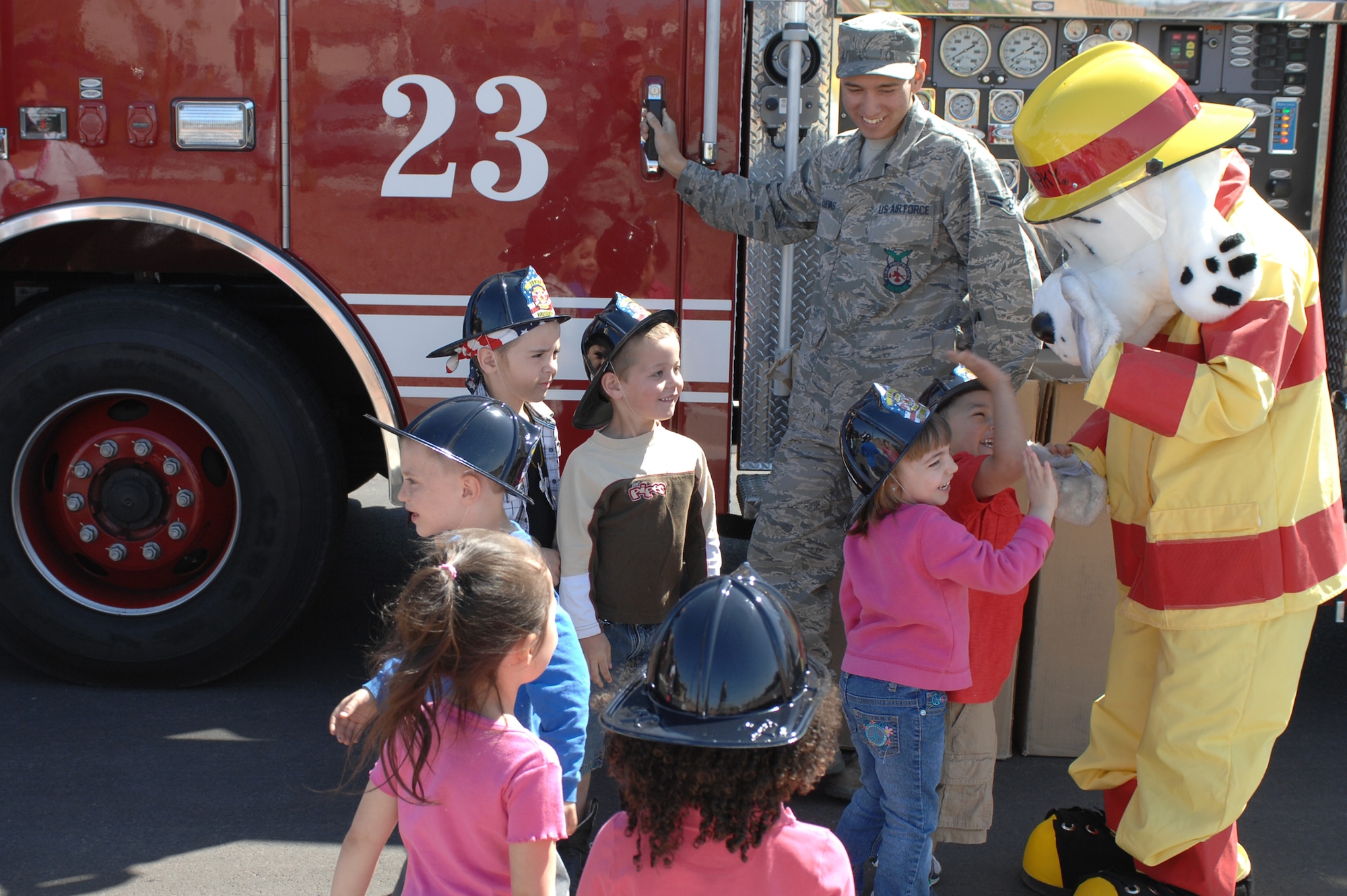 U.S. Air Force Airman 1st Class Jake Cuevas, 99th Civil Engineer Squadron fire protection journeyman, and Sparky the Fire Dog educate children about fire safety at the Child Development Center, April 10, 2012, at Nellis Air Force Base, Nev. While discussing fire safety, firemen from the 99th CES fire department led a tour of a fire truck. (U.S. Air Force photo by Senior Airman Jack Sanders)
  

