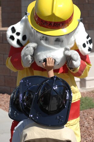 Sparky the Fire Dog entertains children at the Child Development Center during a visit from the 99th Civil Engineer Squadron fire department, April 10, 2012, at Nellis Air Force Base, Nev. Sparky the Fire Dog has been the official mascot of the National Fire Protection Association since 1951. (U.S. Air Force photo by Senior Airman Jack Sanders)  