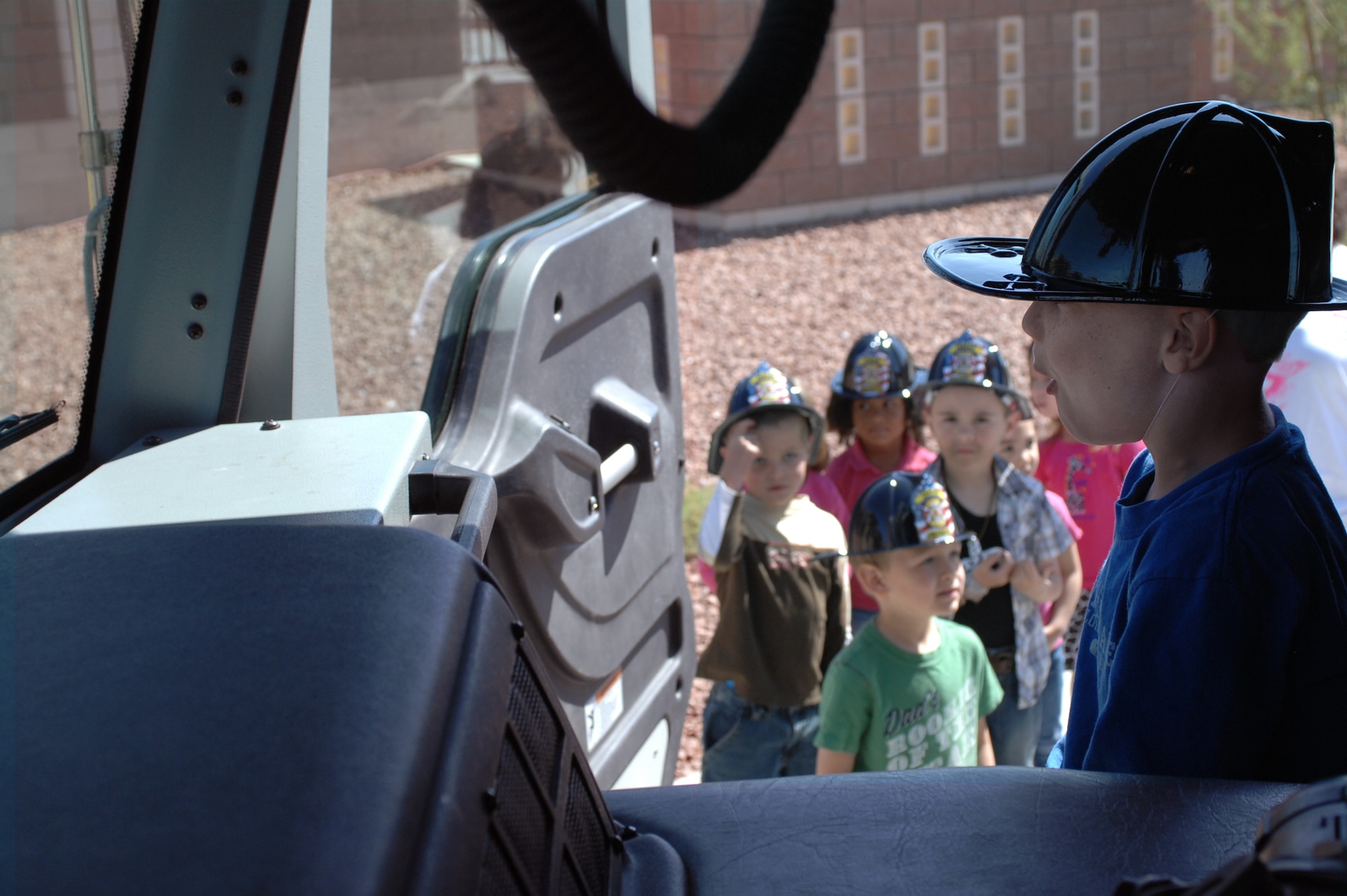Children attending the Child Development Center discover the inside of a fire truck, April 10, 2012, at Nellis Air Force Base, Nev. The 99th Civil Engineer Squadron fire department gave the children a tour of the truck while teaching fire safety lessons. (U.S. Air Force photo by Senior Airman Jack Sanders)
  

