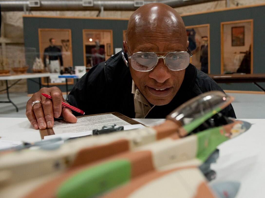 Ray Dixion, an employee of Who’s Hobby in Rapid City, S.D., inspects a scale model of an F-16 Fighting Falcon during the scale model contest at the South Dakota Air and Space Museum in Box Elder, S.D., April 14, 2012. Along with the contest and a variety of exhibits, the museum offered scale model painting demonstrations and drawings throughout the day. (U.S. Air Force photo by Airman 1st Class Kate Thornton/Released)