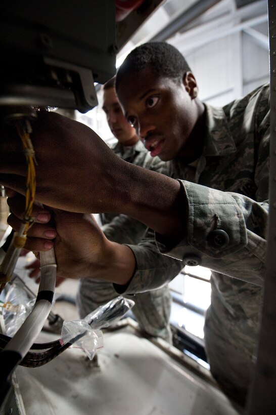 Senior Airman Rashion Walker, 28th Aircraft Maintenance Squadron communication/navigation systems technician, tightens electrical lines during equipment upgrades on a B-1 bomber’s radar system at Ellsworth Air Force Base, S.D., April 11, 2012. The 28th AMXS Avionics Shop technicians installed new processors and receiving units on the radar systems, then tested the system to ensure the new parts worked properly. (U.S. Air Force photo by Airman 1st Class Alystria Maurer/Released)