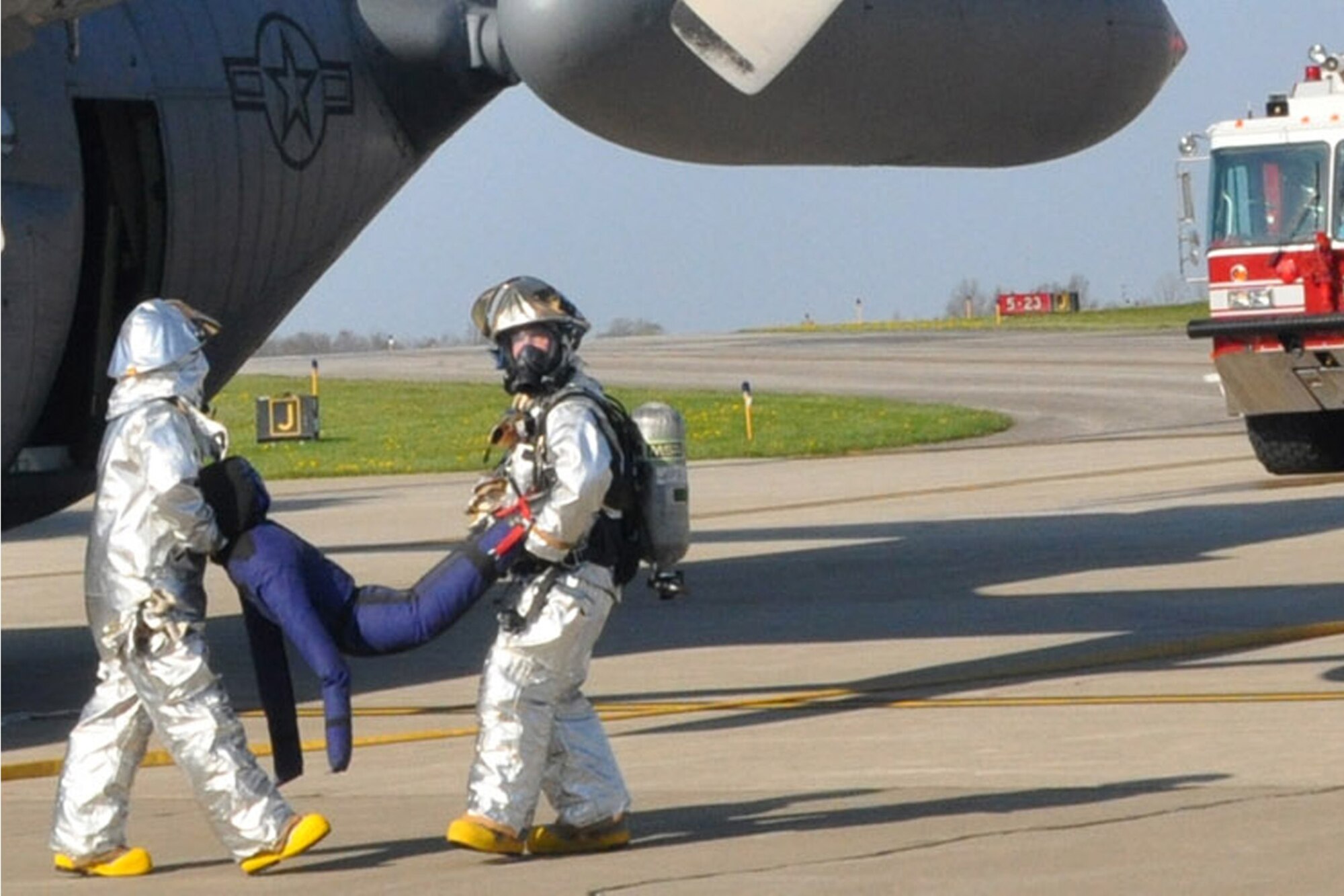 910th Fire Department responders carry a simulated crew member from a C-130 aircraft during an emergency response exercise April 16. The exercise allows the 910th and local first responders to test their mutual aid agreements and is required to be conducted every three years.