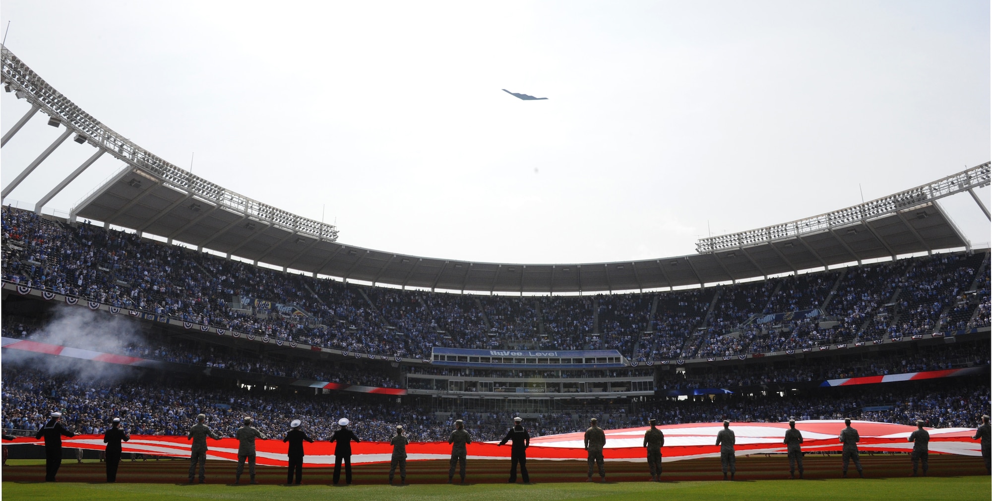 KANSAS CITY, Mo. --A B-2 Spirit flies over Kansas City Royals Opening Day and featured a flag detail at Kauffman Stadium April 13. The flag detail included more than 80 Whiteman Airmen and Soldiers.  The B-2 flew from Whiteman AFB as part of a training mission and was piloted by Lt. Col. Aaron “Pepe” Pepkowitz and Maj. John “Edge” Speer, 394th Combat Training Squadron. The Kansas City Royals lost to the Cleveland Indians, with the final score 8 to 3. (U.S. Air Force Photo/Jennifer Greene)(Released)