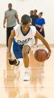 Breshae Brooks, 16, participates in a basketball skills development clinic at the Youth Center April 11, 2012, at Dover Air Force Base, Del. Alvin Jackson, director of 100% Tobacco-Free Sports, uses the popularity of basketball to motivate youth to stay away from tobacco, drugs and alcohol. A.J. English, Former National Basketball Association player for the Washington Bullets, conducted the clinic. (U.S. Air Force photo by Roland Balik)