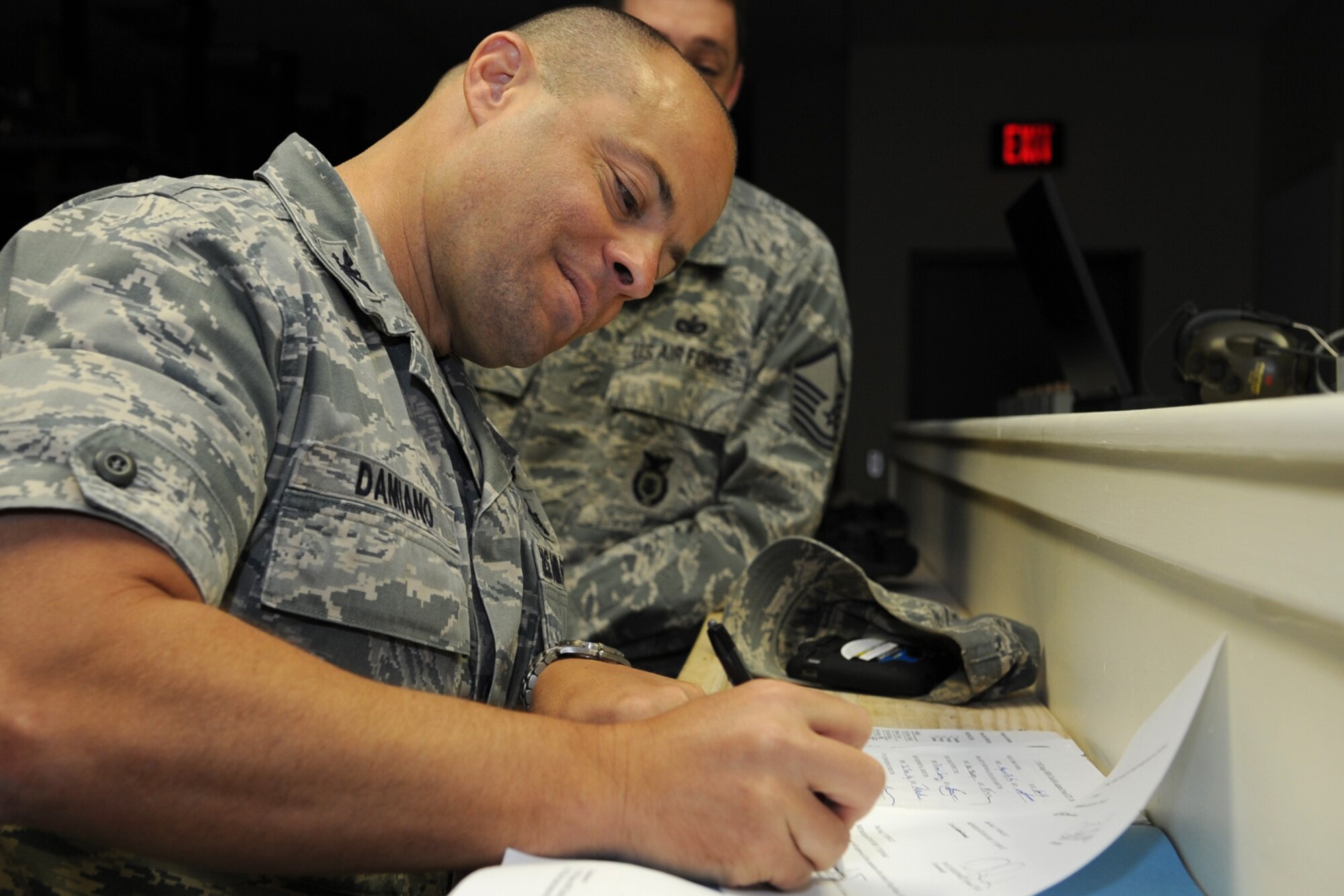 GOODFELLOW AIR FORCE BASE, Texas -- Col. Mark Damiano, 17th Training Wing Commander, signs the paperwork officially opening the remodeled firing range April 16. The range has 14 firing lanes and includes night time lighting for security forces training. (U.S. Air Force photo/Staff Sgt. Laura R. McFarlane)