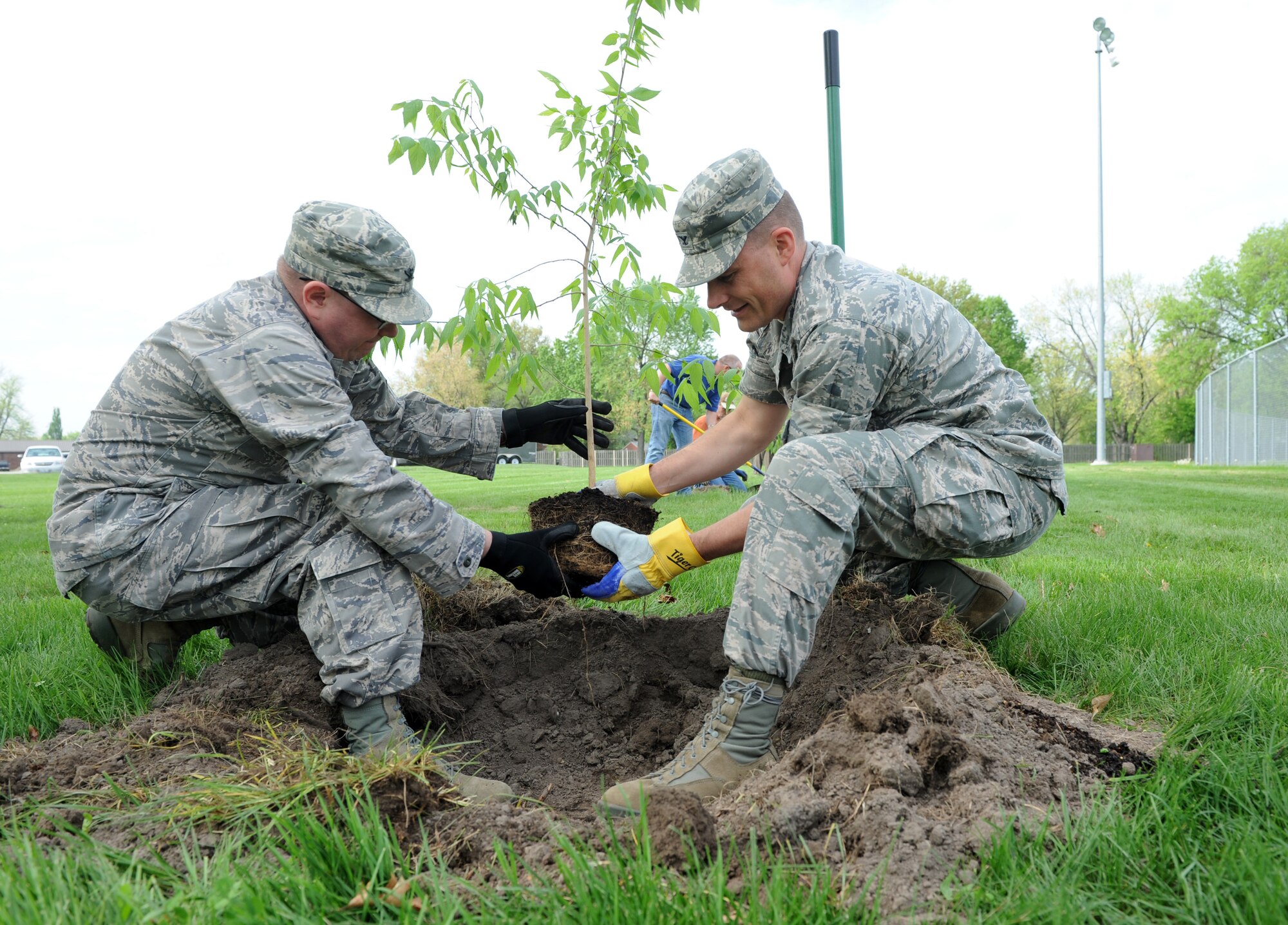 Col. Mike Hornitschek, 375th Air Mobility Wing commander, and Col. Mark Whinnery, 375th Mission Support Group commander, plant a hackberry tree April 3 at Scott Air Force Base, Ill. Hornitschek and Whinnery plant the tree to kick off earth week which is April 16 to 20. The Civil Engineer Squadron will plant a total of 145 trees over the month to celebrate earth week and arbor day. (U.S. Air Force photo/Airman 1st Class Kristina Lynch)