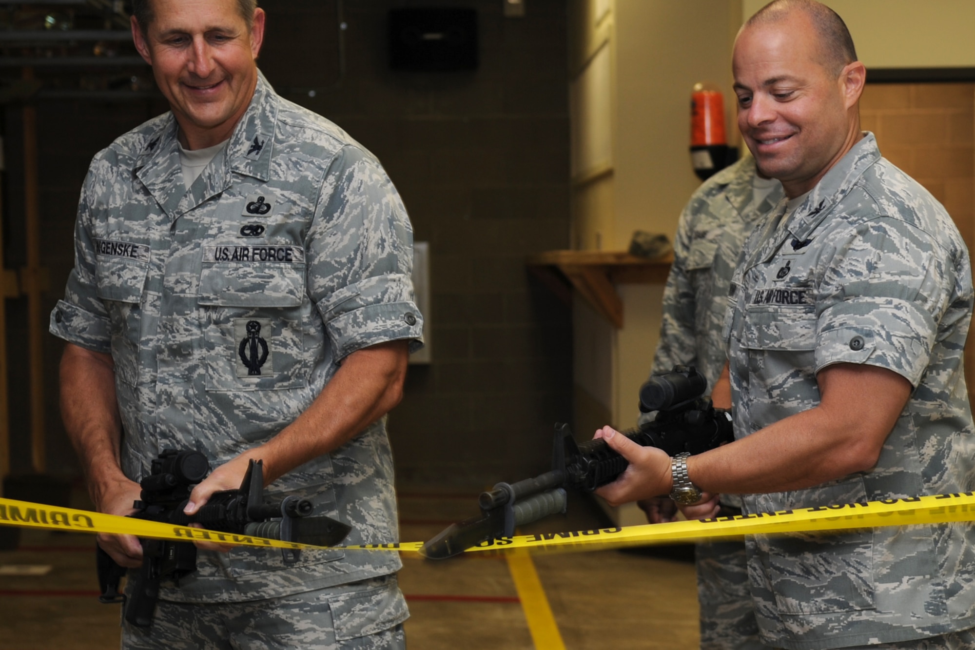 GOODFELLOW AIR FORCE BASE, Texas -- Col. Paul Bugenske, 17th Mission Support Group Commander, and Col. Mark Damiano, 17th Training Wing Commander, “cut” the ribbon officially opening the remodeled firing range April 16. The range provides 14 indoor firing lanes. (U.S. Air Force photo/Staff Sgt. Laura R. McFarlane)