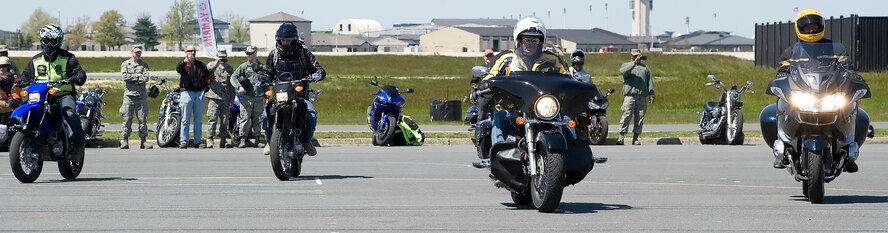 Team Dover members participate in a slow-drag competition during April 13, 2012, during Motorcycle Safety Day, at Dover Air Force Base, Del. Motorcycle Safety Day is a yearly event held to ensure riders and motorists are aware of increased safety measures while riding. (U.S. Air Force photo by Adrian R. Rowan)