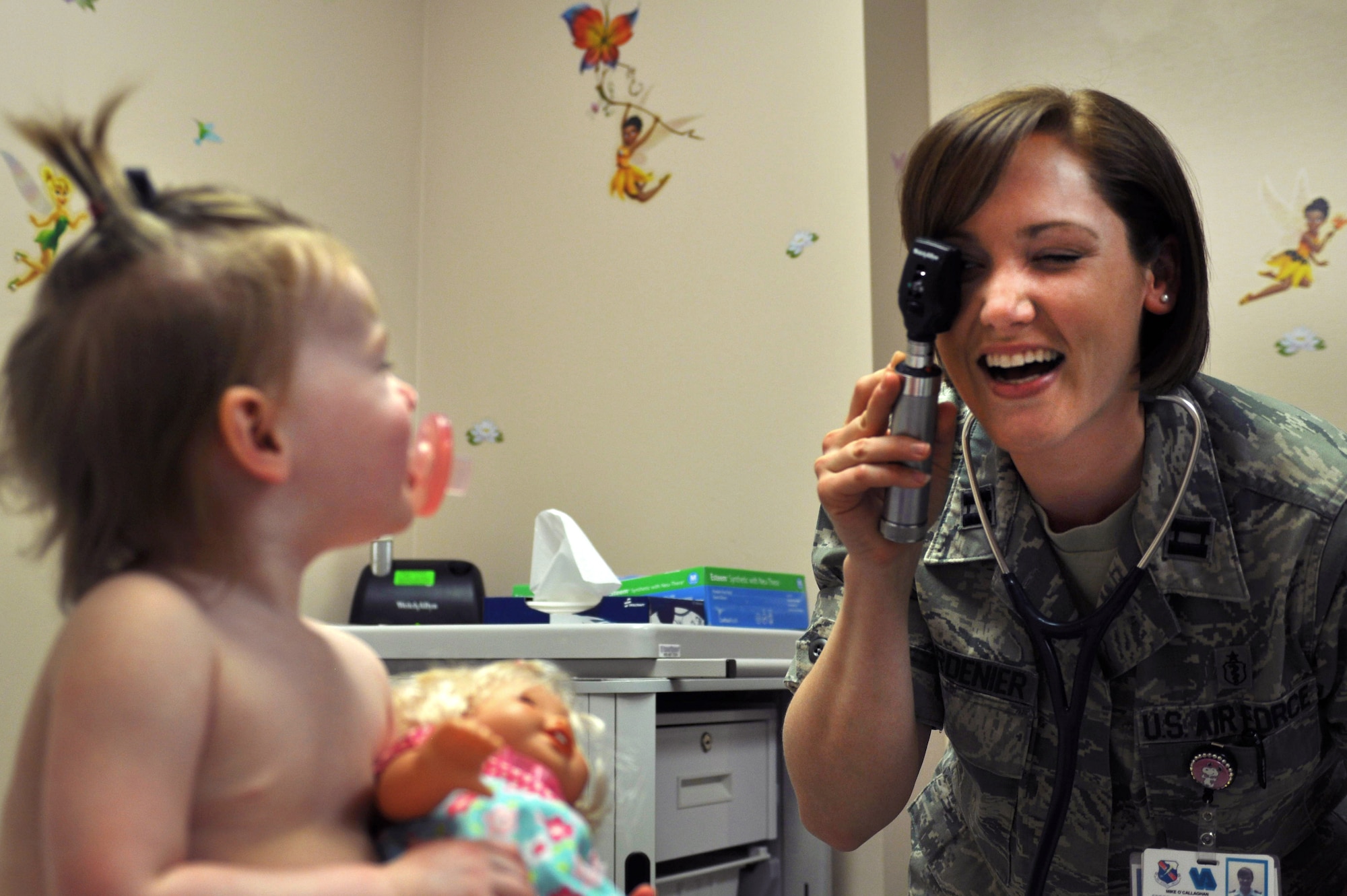 U.S. Air Force Capt. Andrea Guardenier, 99th Medical Group pediatrician, uses a  ophthalmoscope to play with Soquel Baumgardner, daughter of Tech. Sgt. Jay Baumgardner and Adelaide Baumgardner April 5, 2012 at Nellis Air Force Base, Nev. The 99th Medical Group's pediatric clinic provides a friendly atmosphere for children. (U.S. Air Force photo by Staff Sgt. William P.Coleman)
  

