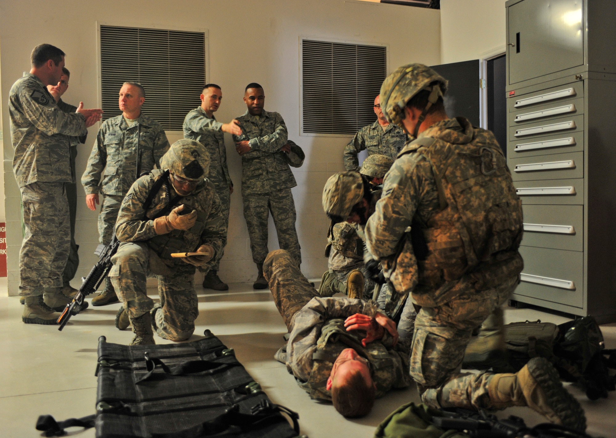 U.S. Air Force Airmen with the 820th Base Defense Group provide care to a casualty during a simulation for Brig. Gen. Daniel Wyman, Air Combat Command surgeon general, at Moody Air Force Base, Ga., April 12, 2012. The simulation showed how medics integrate with the unit and how they are used when retrieving a casualty under fire. (U.S. Air Force photo by Staff Sgt. Stephanie Mancha/Released)