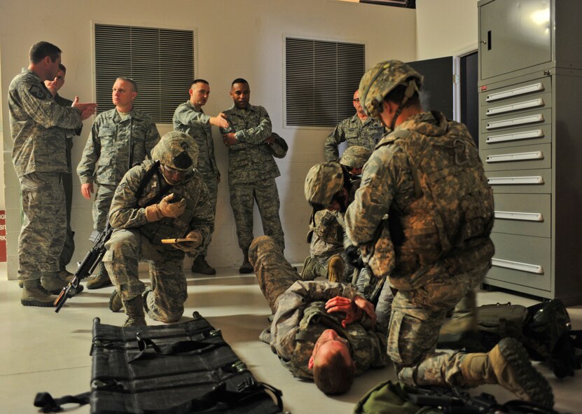 U.S. Air Force Airmen with the 820th Base Defense Group provide care to a casualty during a simulation for Brig. Gen. Daniel Wyman, Air Combat Command surgeon general, at Moody Air Force Base, Ga., April 12, 2012. The simulation showed how medics integrate with the unit and how they are used when retrieving a casualty under fire. (U.S. Air Force photo by Staff Sgt. Stephanie Mancha/Released)