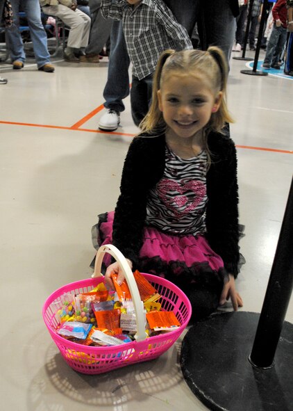 Isabella Cortez, 5, smiles for the camera before choosing a piece of candy as a prize for playing a game. Candy and small toys were given away at the carnival to children of all ages who attended the event. (U.S. Air Force photo/Airman 1st Class Katrina Heikkinen)