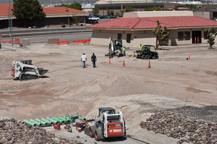 U.S. Air Force Airmen, 99th Civil Engineer Squadron, construct a roundabout at the intersection of Ellesworth avenue and Fitzgerald boulevard April 16, 2012, at Nellis Air Force Base, Nev. Roundabouts are used to alleviate traffic congestion, reduce fuel consumption, air pollution and accidents. (U.S. Air Force photo by Airman 1st Class Jason Couillard)