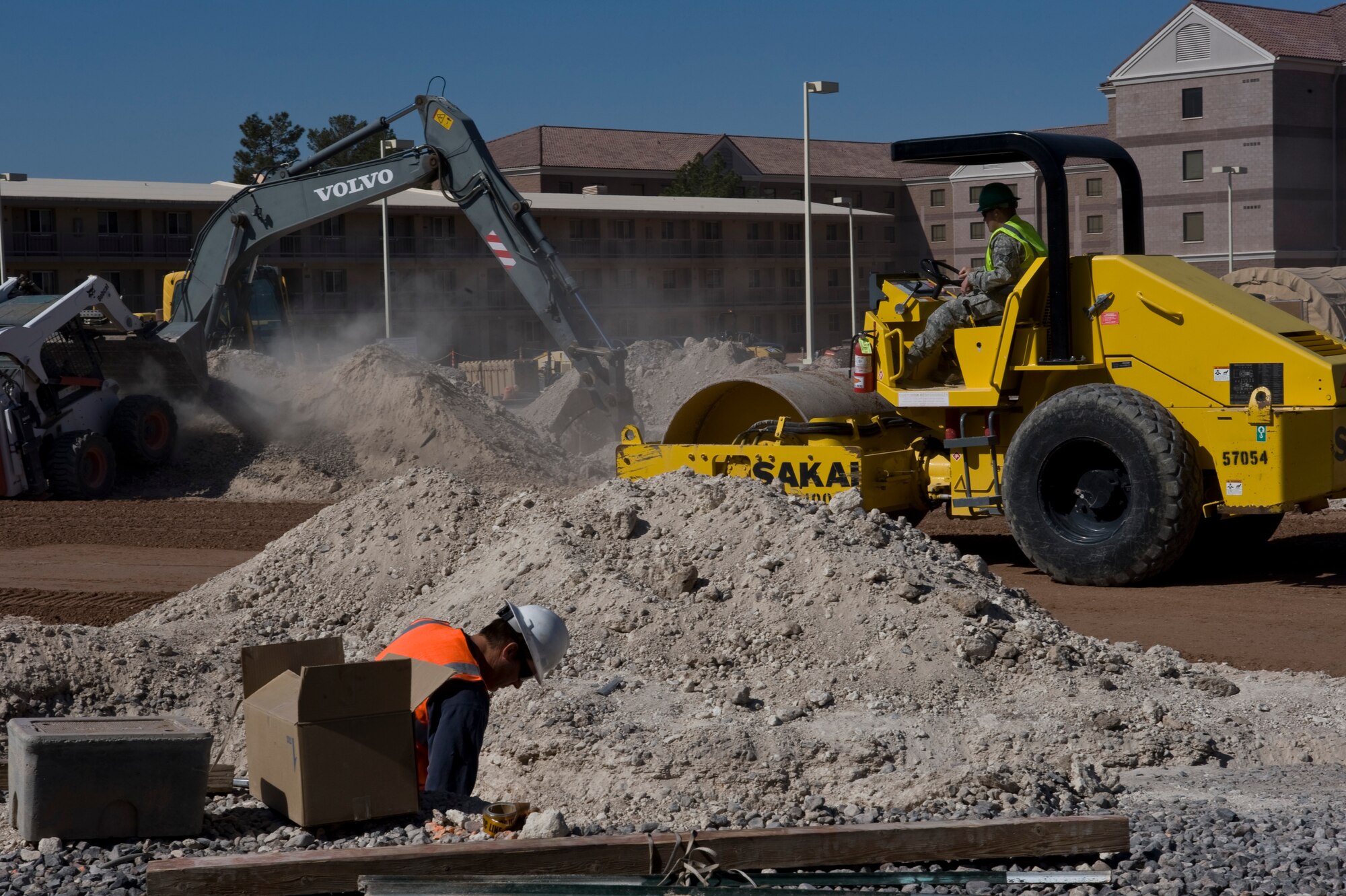 U.S. Air Force Airmen, 99th Civil Engineer Squadron, continue the construction of a roundabout April 14, 2012, at Nellis Air Force Base, Nev. The roundabout allows for traffic to pass through the intersection with the minimal possible stops, preventing fuel waste as traffic moves across base more efficiently during peak travel times.  (U.S. Air Force photo by Airman 1st Class Matthew Lancaster)
