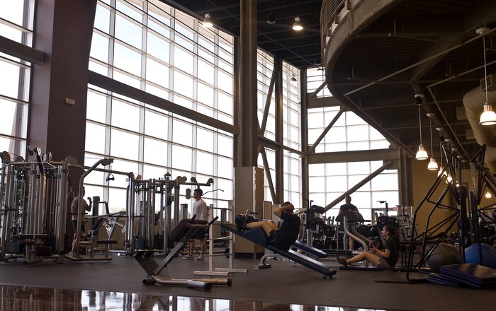 U.S. Air Force Airmen and dependents use new fitness equipment at the Warrior Fitness Center April 12, 2012, at Nellis Air Force Base, Nev. The Warrior Fitness Center's design reduces energy consumption by keeping out ultraviolet energy, efficiently heating and cooling common areas and automatically shutting off lights when spaces aren't being used. (U.S. Air Force photo by Staff Sgt. Christopher Hubenthal)