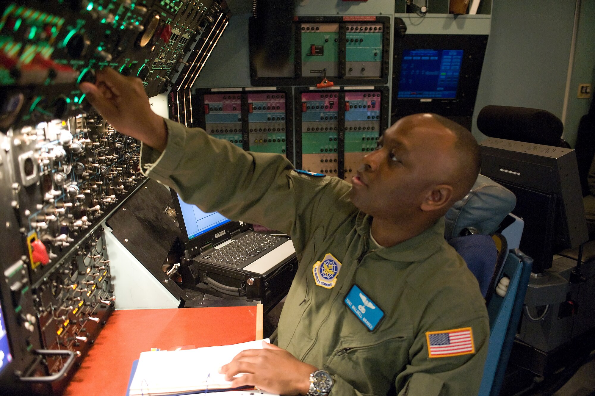 Tech. Sgt. Waldell Graves, a flight engineer journeyman with the 9th Airlift Squadron, goes through checklist procedures during a training exercise April 17, 2012, at Dover Air Force Base, Del. Graves is part of the first formal training unit for the C-5M Super Galaxy, and is training to become proficient with the aircraft. (U.S. Air Force photo by Steve Kotecki)