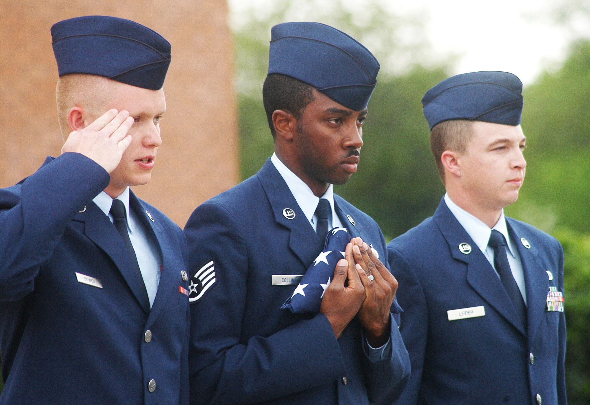 L-R, Airman 1st Class Tyler Bowen, Staff Sgt. Maurice Collins  and Senior Airman Clayton Leirer report to Col. Roger Johnson, 78th Mission Support Group commander, that the flag is secure during a retreat ceremony in honor of the retirement of Chief Master Sgt. Eric R. Jaren, Headquarters  Air Force Materiel Command command chief. (U. S. Air Force photo by Sue Sapp)