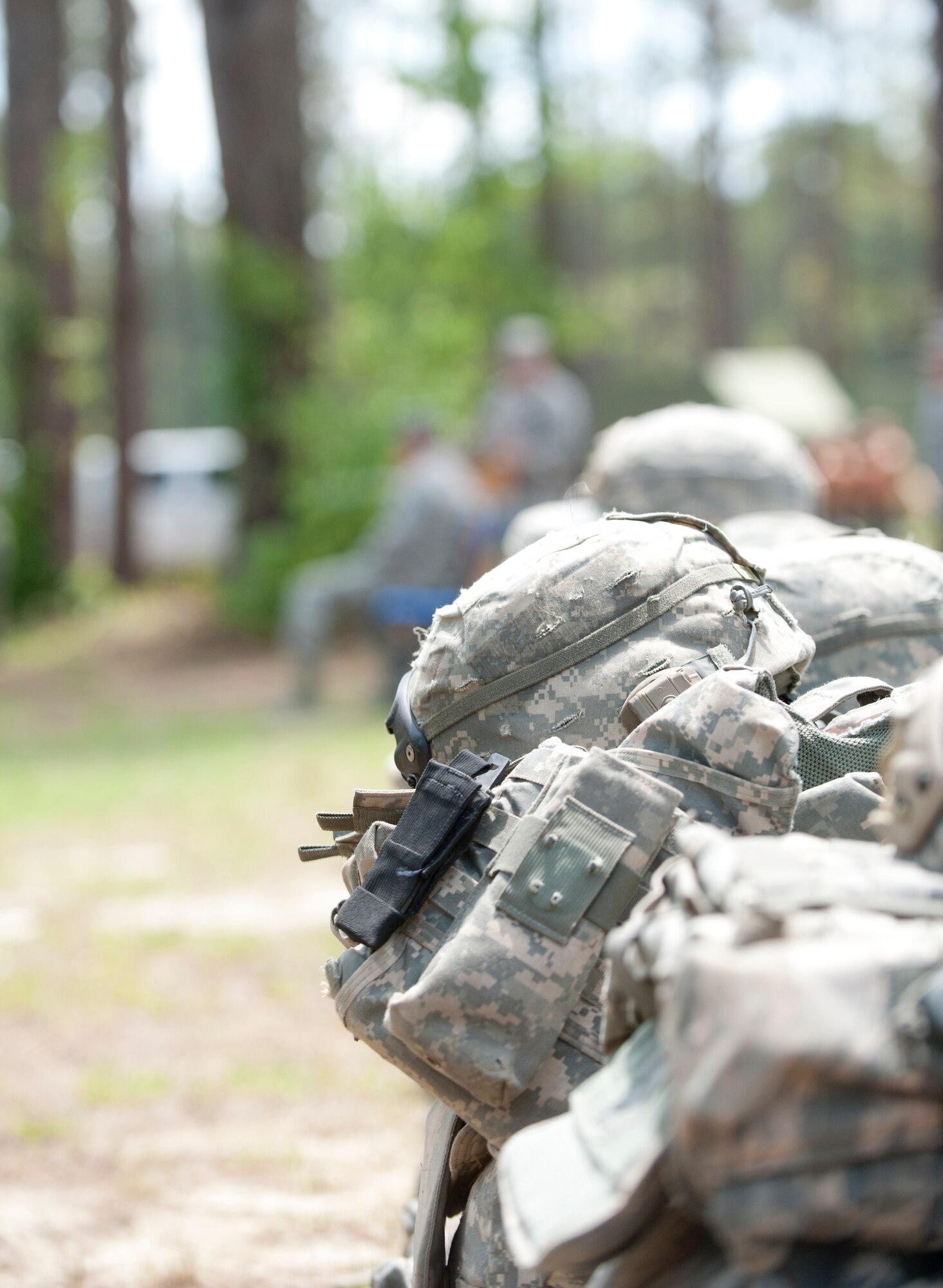 Rows of gear used by the graduates of the Tactical Leader’s Course class 12-2 sit on the ground during a graduation ceremony at Moody Air Force Base, Ga., April 13, 2012. The course consists of leadership based mounted and dismounted patrols, field training exercises, and troop leading exercises. (U.S. Air Force photo by Airman 1st Class Jarrod Grammel/Released)
