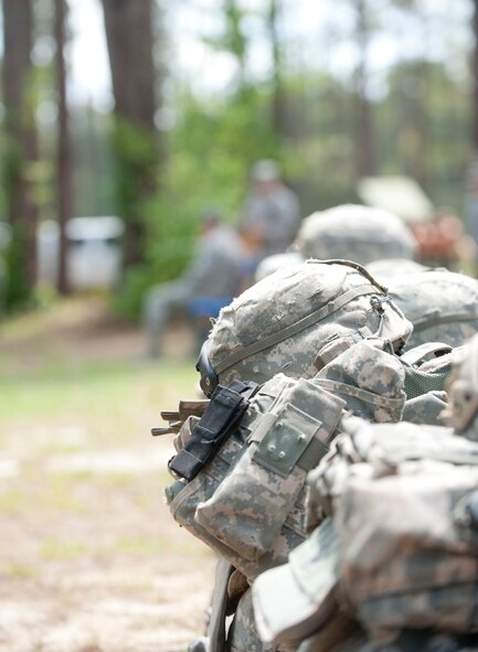 Rows of gear used by the graduates of the Tactical Leader’s Course class 12-2 sit on the ground during a graduation ceremony at Moody Air Force Base, Ga., April 13, 2012. The course consists of leadership based mounted and dismounted patrols, field training exercises, and troop leading exercises. (U.S. Air Force photo by Airman 1st Class Jarrod Grammel/Released)
