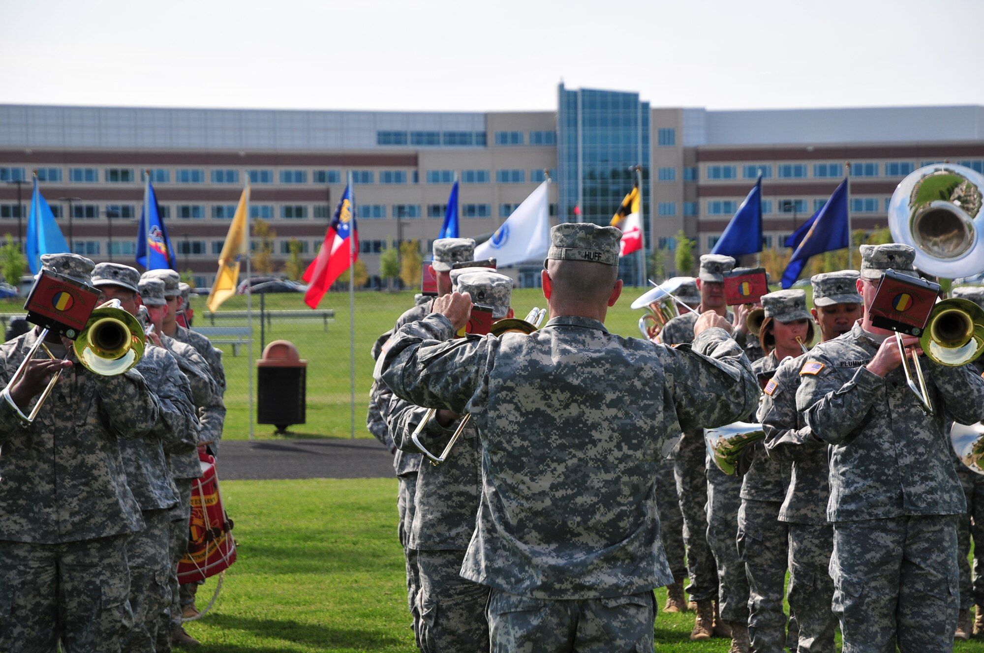 The U.S. Army Training and Doctrine Command band plays a rendition of “The Army Goes Rolling Along“ during the Transfer of Authority ceremony at Fort Eustis'’ Murphy Field April 13. TRADOC's headquarters is visible in the background. (U.S. Army photo by Sgt. Edwin Rodriguez/Released)