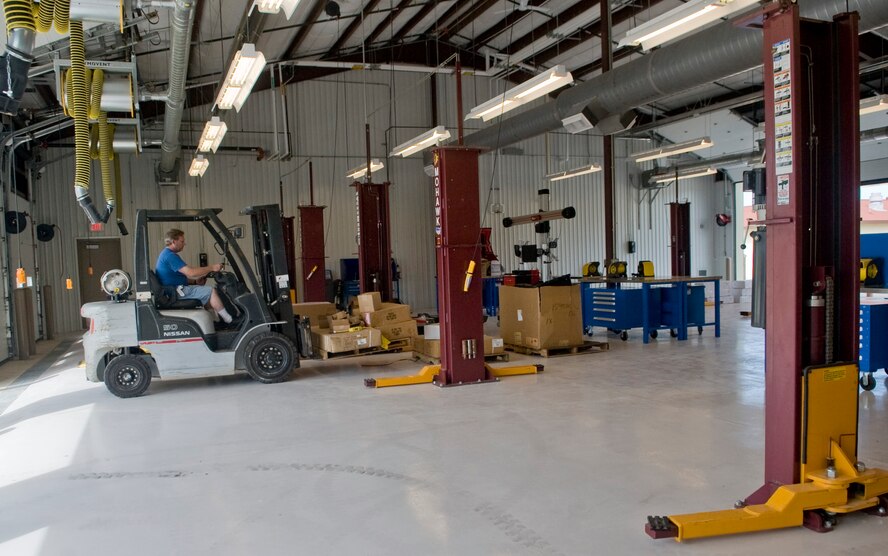 Tom Hunnicutt, 2nd Force Support Squadron mechanic, moves equipment into the new Auto Hobby Shop on Barksdale Air Force Base, La., April 17. The Auto Hobby Shop will be closed from April 18 through May 1 during the transition from its old facility. The new building has 10 workstations for auto hobbyists, and routine maintenance and repair along with a new auto car wash. (U.S. Air Force photo/Senior Airman Kristin High)(RELEASED)