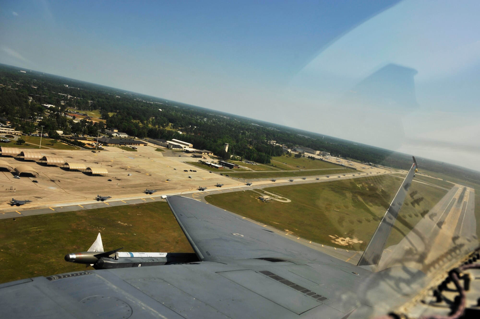 A U.S. Air Force F-15E Strike Eagle from the 4th Fighter Wing takes off as nearly 70 other F-15s taxi to the runway below during a Turkey Shoot training mission on Seymour Johnson Air Force Base, N.C., April 16, 2012.  The wing generated nearly 70 aircraft to destroy more than 1,000 targets on bombing ranges across the state to commemorate the 4th Fighter Wing's victory over the Luftwaffe on April 16, 1945.  (U.S. Air Force Photo by Staff Sgt. Eric Harris/Released)