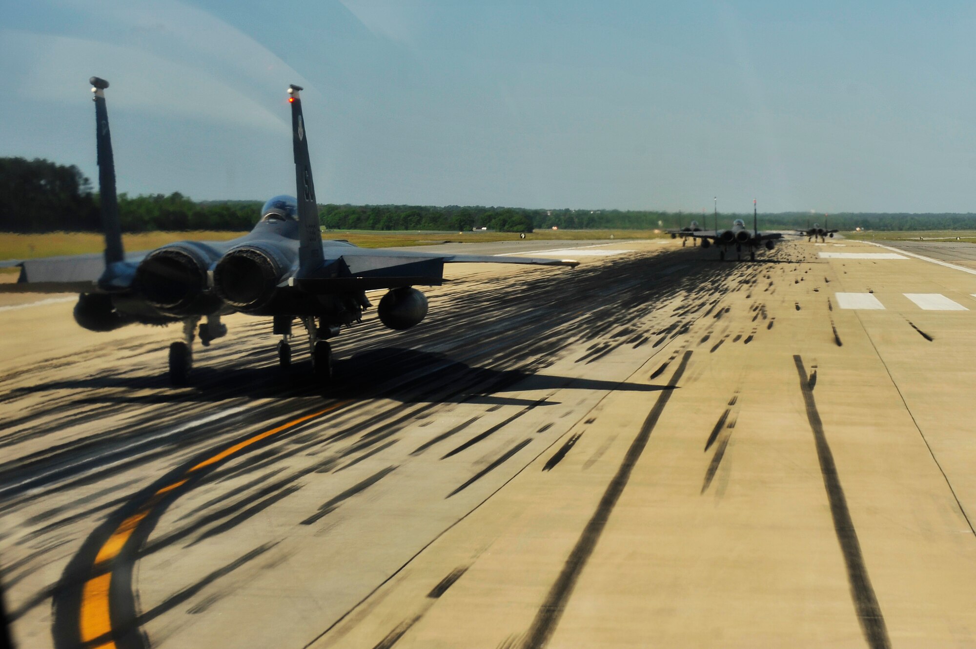 U.S. Air Force F-15E Strike Eagles from the 4th Fighter Wing perform an "Elephant Walk" as they taxi down the runway during a Turkey Shoot training mission on Seymour Johnson Air Force Base, N.C., April 16, 2012.  The wing generated nearly 70 aircraft to destroy more than 1,000 targets on bombing ranges across the state to commemorate the 4th Fighter Wing's victory over the Luftwaffe on April 16, 1945.  (U.S. Air Force Photo by Staff Sgt. Eric Harris/Released)
