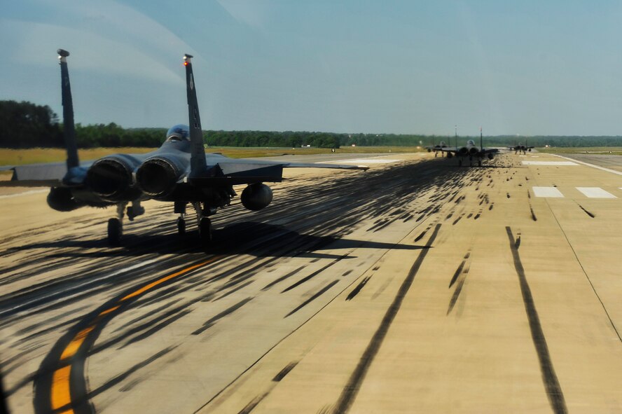 U.S. Air Force F-15E Strike Eagles from the 4th Fighter Wing perform an "Elephant Walk" as they taxi down the runway during a Turkey Shoot training mission on Seymour Johnson Air Force Base, N.C., April 16, 2012.  The wing generated nearly 70 aircraft to destroy more than 1,000 targets on bombing ranges across the state to commemorate the 4th Fighter Wing's victory over the Luftwaffe on April 16, 1945.  (U.S. Air Force Photo by Staff Sgt. Eric Harris/Released)