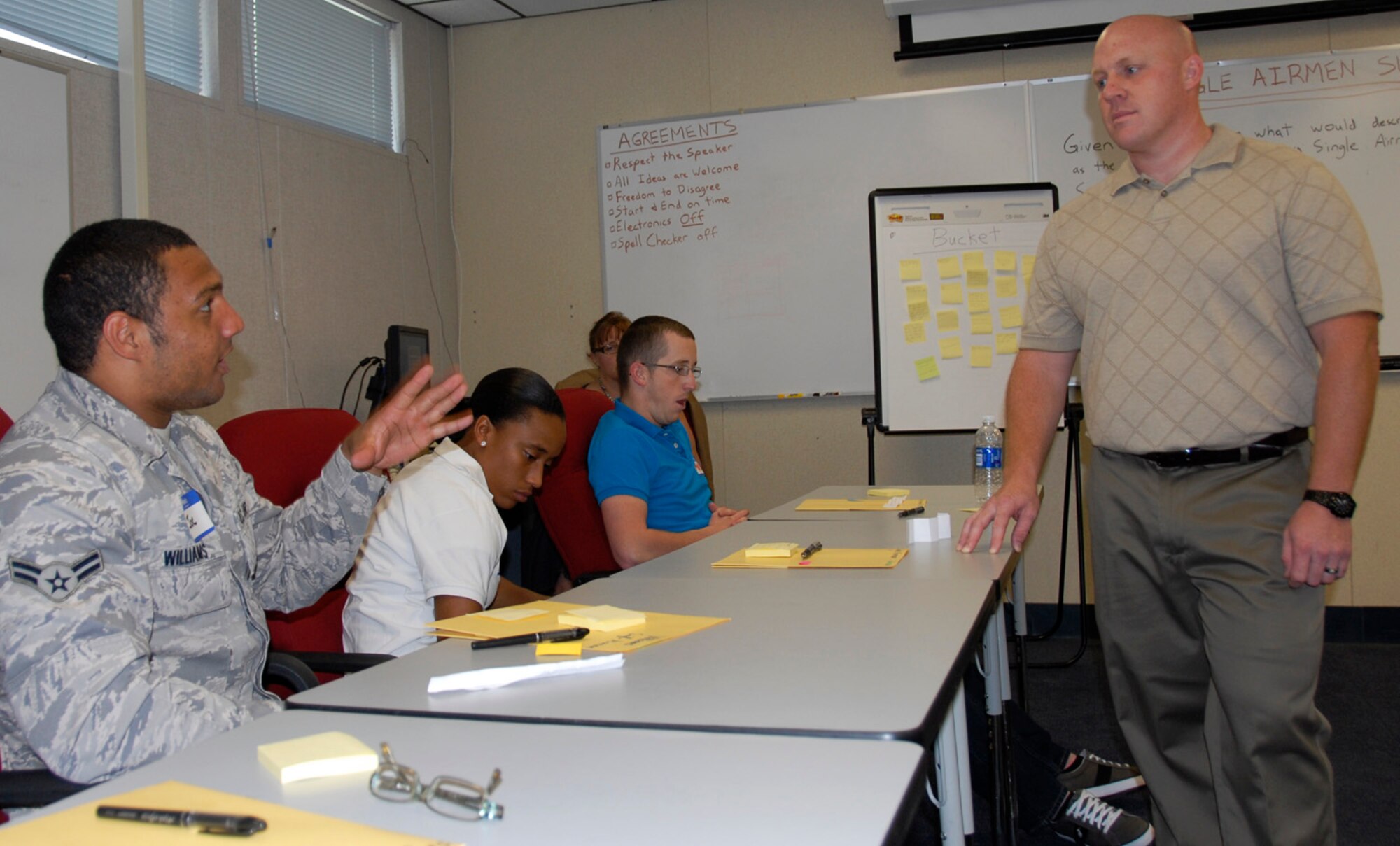 Airman 1st Class Joe Williams, a member of the 96th Medical Support Squadron, shares an idea with Daniel Mayo, who facilitated the single Airman support working group at the Caring for People forum.  (U.S. Air Force photo/Kevin Gaddie) 