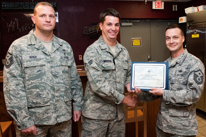 (Left to right) U.S. Air Force Master Sgt. Warren Benge, 57th Aircraft Maintenance Squadron first sergeant, Senior Airman Alexander MacPhail, 414th Combat Training Squadron system administrator, and Master Sgt. Brian Noethlich, 57th Operations Support Squadron first sergeant pose for the presentation of the first ever Diamond Sharp Award presentation April 5, 2012, at Nellis Air Force Base, Nev.

The First Sergeant's Diamond Sharp Award is designed to recognize an individual who truly stands out with abilities, sheer drive and characteristic traits most others do not possess. MacPhail was presented the award when he and his team installed the Microsoft Windows 7 operating system on 200 computers within three days and verified vital Integrated Maintenance Data System connectivity to 12 hangars in support of over 1000 Red Flag 12-3 missions flown. (U.S. Air Force photo by Airman 1st Class Jason Couillard)