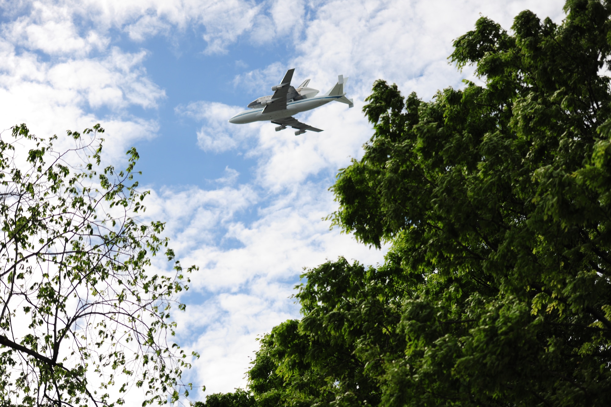 A NASA Shuttle Carrier aircraft carrying the space shuttle Discovery flies above the National Mall with a NASA chase plane escort April 17. The retired shuttle landed at the Washington Dulles International Airport for delivery to the National Air & Space Museum’s Udvar-Hazy Center. (U.S. Air Force photo/Senior Airman Amber Russell)