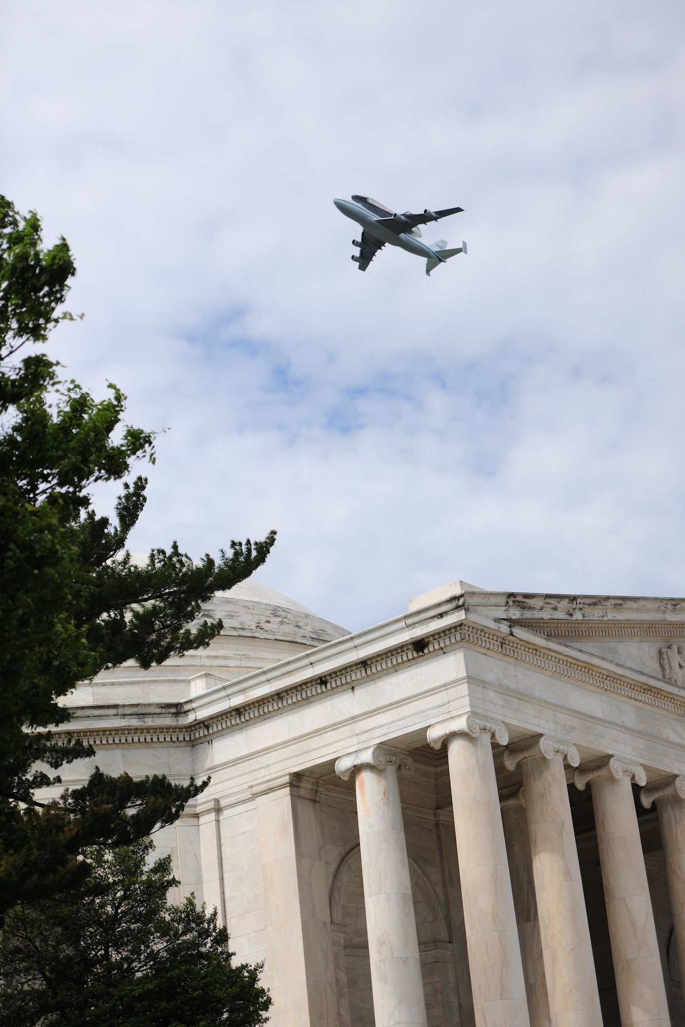 A NASA Shuttle Carrier aircraft carrying the space shuttle Discovery flies above the National Mall with a NASA chase plane escort April 17. The retired shuttle landed at the Washington Dulles International Airport for delivery to the National Air & Space Museum’s Udvar-Hazy Center. (U.S. Air Force photo/Senior Airman Amber Russell)