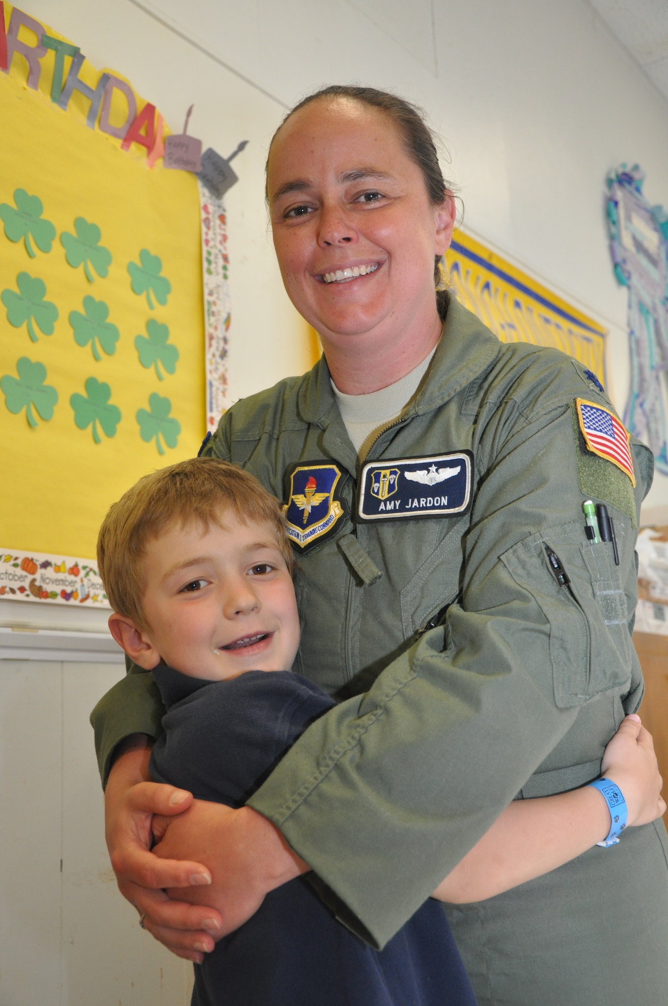 Lt. Col. Amy Jardon, 314th Airlift Wing chief of safety, embraces her first-grade son, William Mainstone, while visiting him for lunch at Arnold Drive Elementary School, April 17, 2012, at Little Rock Air Force Base, Ark. Mainstone said he wants to be just like his mom when he grows up. (U.S. Air Force photo by Airman 1st Class Regina Agoha)