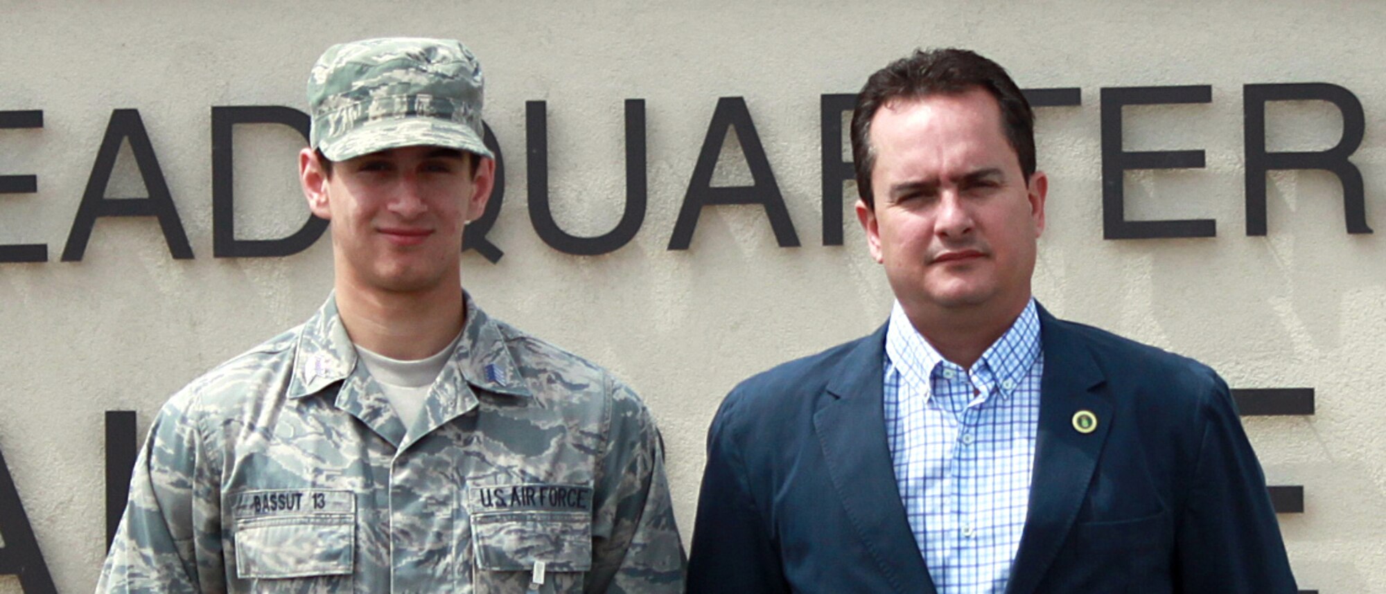 Cadet Senior Master Sgt. Aaron Bassut (left) stands next to his father, Carlos Bassut, 95th Force Support Squadron director, in front of 95th Air Base Wing Headquarters.  Cadet Bassut is an aspiring doctor who is a junior at the Air Force Academy and wanted to visit Edwards to shadow doctors within the 95th Medical Group.  Mr. Bassut called the 95th MDG and helped his son shadow doctors during his spring break from March 26 to 30.  (Courtesy photo)