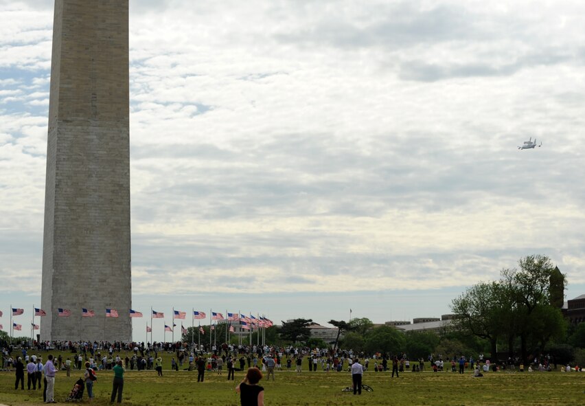 The space shuttle Discovery makes its final voyage April 17 as it rides piggyback on a modified Boeing 747 by the George Washington Monument in Washington, D.C.  The shuttle circled the National Mall several times before landing at Dulles International Airport, where it made the rest of the journey to the Smithsonian National Air and Space Museum annex in Virginia by truck.  (U.S. Air Force photo/Senior Airman Torey Griffith)

