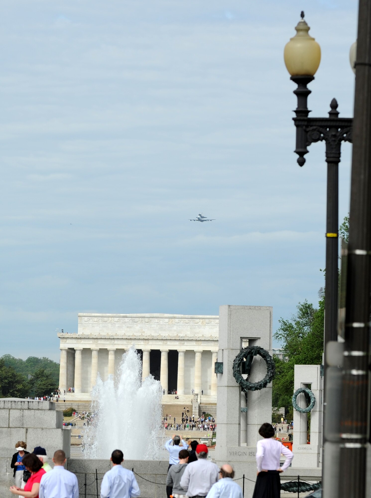 The space shuttle Discovery makes its final voyage April 17 as it rides piggyback on a modified Boeing 747 above the Lincoln Memorial in Washington, D.C.  The shuttle circled the National Mall several times before landing at Dulles International Airport, where it made the rest of the journey to the Smithsonian National Air and Space Museum annex in Virginia by truck.  (U.S. Air Force photo/Senior Airman Torey Griffith)

